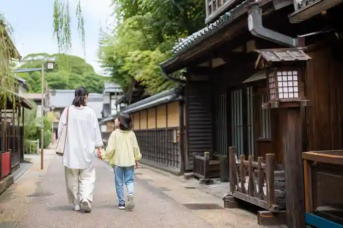 西初石近隣公園の芝生と木陰を親子が散策する場面